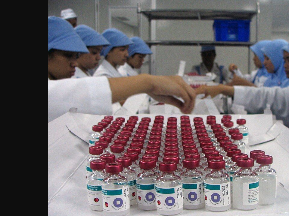 Archival 2017 image of generic vaccine vials being inspected at BioFarma in Indonesia; this is not an RSV vaccine or a Welsh clinic