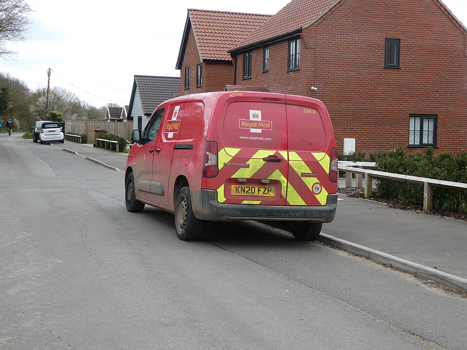 Archival 2021 photograph of a red Royal Mail delivery van on a street in Wymondham, Norfolk; it does not depict the current union dispute.
